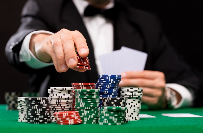 10693991-poker-player-with-cards-and-chips-at-casino
